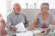 Senior couple discussing finances at home Senior couple discussing finances at home