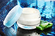Opened glass jar of cream and aloe