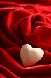 White stone heart on the red velvet fabric