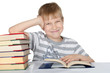 The boy reads the book isolated on white