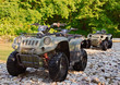 ATV's parked on the shore of a mountain river.