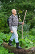 An elderly man with a backpack tourist goes into the thickets