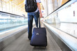 Traveler with a suitcase on the speedwalk