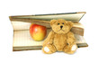book, small bear and apple isolated on white background