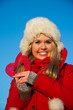 woman in red coat holding heart shape