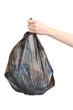 black garbage bag with trash in hand isolated on white