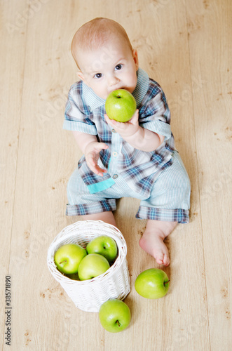 Photo: little boy with a basket of apples little boy with a basket of apples