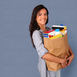 Young woman carrying bag of grocery