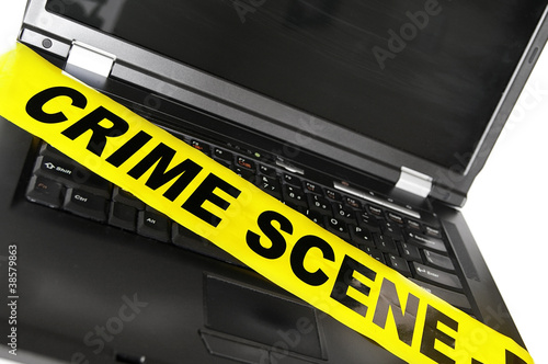Photo: laptop computer with yellow crime scene tape laptop computer with yellow crime scene tape