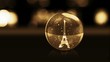 golden glass ball with snow and Eiffel Tower