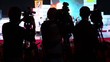 Silhouettes of operators on workplace in row of few cameras