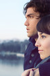 Romantic couple staring to horizon embraced