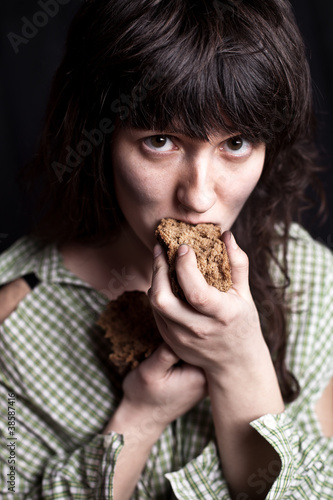 Photo: beggar woman eating bread beggar woman eating bread