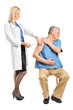 Female doctor applying a syringe to an elderly man Female doctor applying a syringe to an elderly man