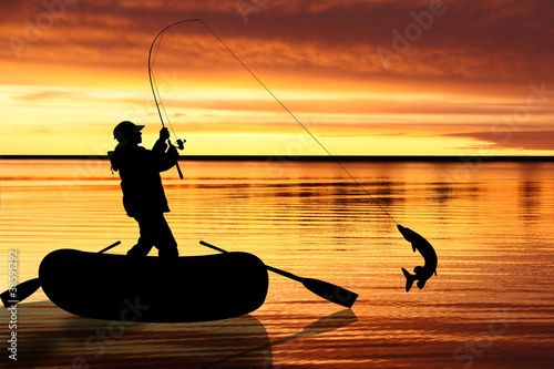 Photo: Fishermen in boat at sunset Fishermen in boat at sunset