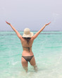 young woman in sea with open hands