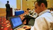 Elnur Amikishiyev looks at conferences in laptop