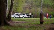 Two cops near police car speak with violators