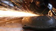 Men at work grinding steel