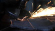 Men at work grinding steel