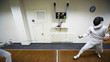 Boy does girl prick in training sword fencing at club