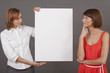 two women with blank white board