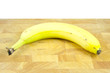 banana laying on chopping board