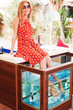 Young girl gets fish spa procedure in a beautiful blue water