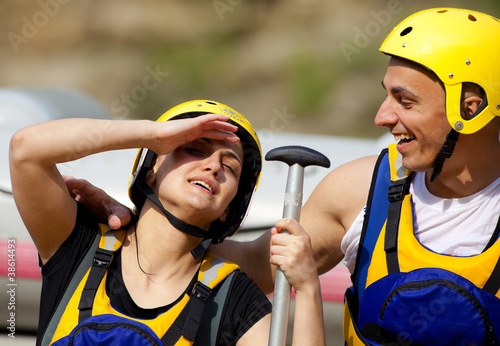 Photo: Happy couple rafting equipment Happy couple rafting equipment