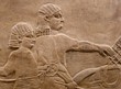 Ancient Assyrian wall carving of men