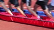 Five men team walk with legs in long merged shoes Five men team walk with legs in long merged shoes