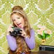 hip retro little girl shooting photo on vintage camera