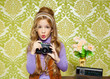 hip retro little girl shooting photo on vintage camera