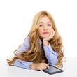 blond student kid with ebook tablet pc portrait in desk