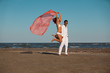 happy, young couple walking along the seashore