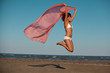 beautiful woman jumping for joy desert beach