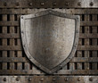 aged metal shield on wooden medieval gates aged metal shield on wooden medieval gates