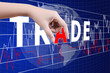 Hand putting Trade word on the stock market