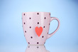 Pink cup and tea bag with red heart-shaped label
