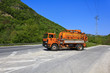 Orange vacuum truck roadside turnout