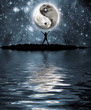 Man in front of moon with the sign of the yin and yang