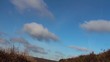 Fluffy white clouds passing by
