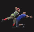 Foto: A couple of young man and woman dancing breakdance in the dark. A couple of young man and woman dancing breakdance in the dark.
