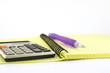 Calculator and pen on the yellow writing-book Calculator and pen on the yellow writing-book