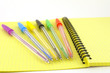 Color pens on the yellow writing-book Color pens on the yellow writing-book