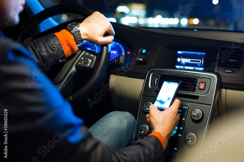 Photo: Driving a car at night -man driving his modern car at night Driving a car at night -man driving his modern car at night