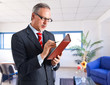 Businessman checking his agenda Businessman checking his agenda
