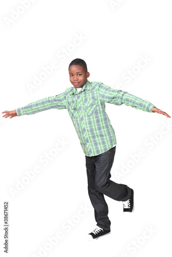 Photo: Cute african boy balancing on one leg Cute african boy balancing on one leg