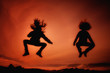 Jumping girls having fun at sunset