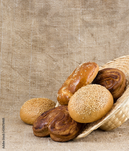 Photo: panary rolls pour out from a basket panary rolls pour out from a basket